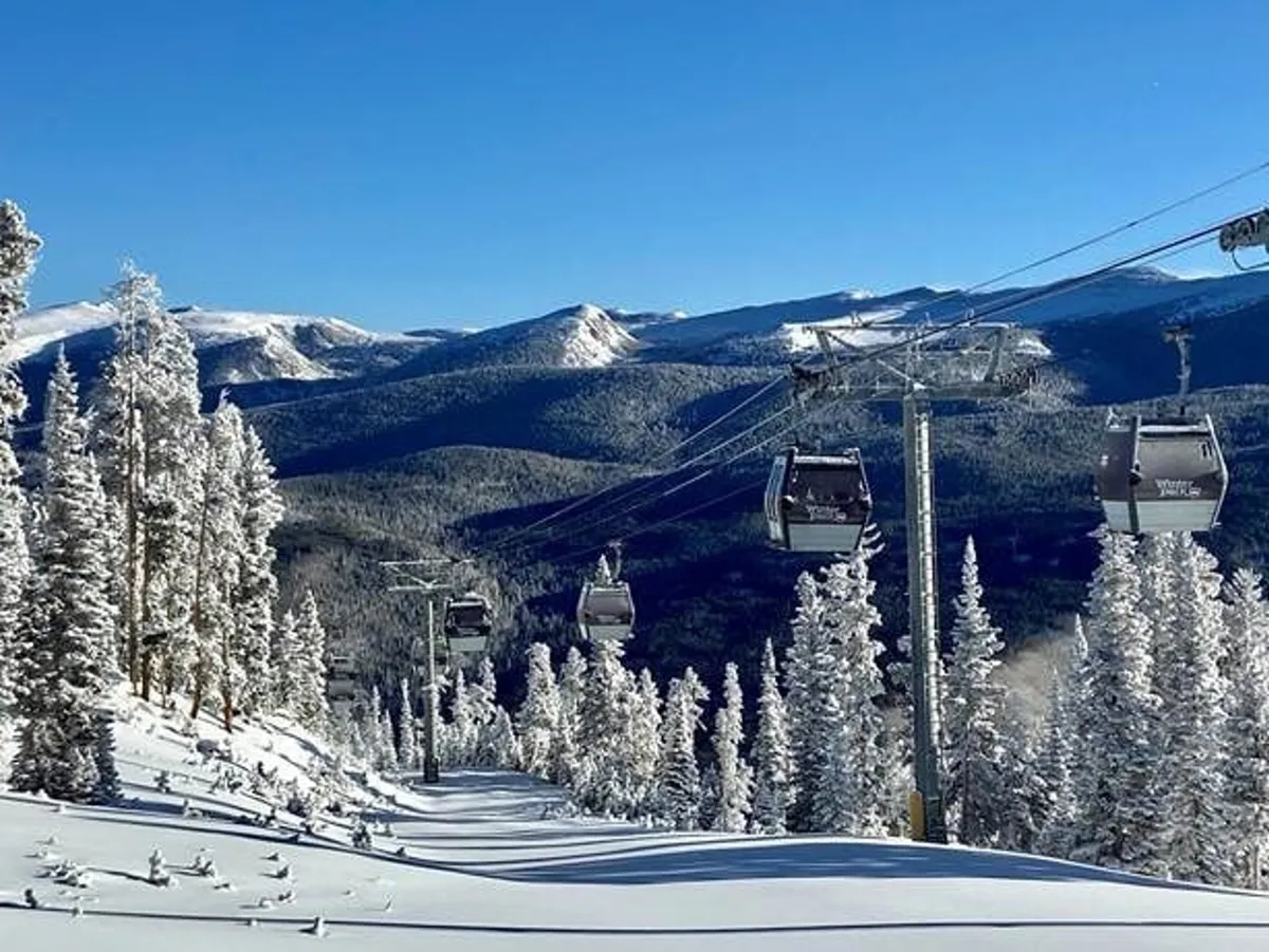 A sweeping exterior shot showcasing a gondola lift ascending snowy slopes, with expansive mountain views and pine trees framing the scene. The atmosphere is adventurous and tranquil, capturing the excitement of winter sports and mountain activities.